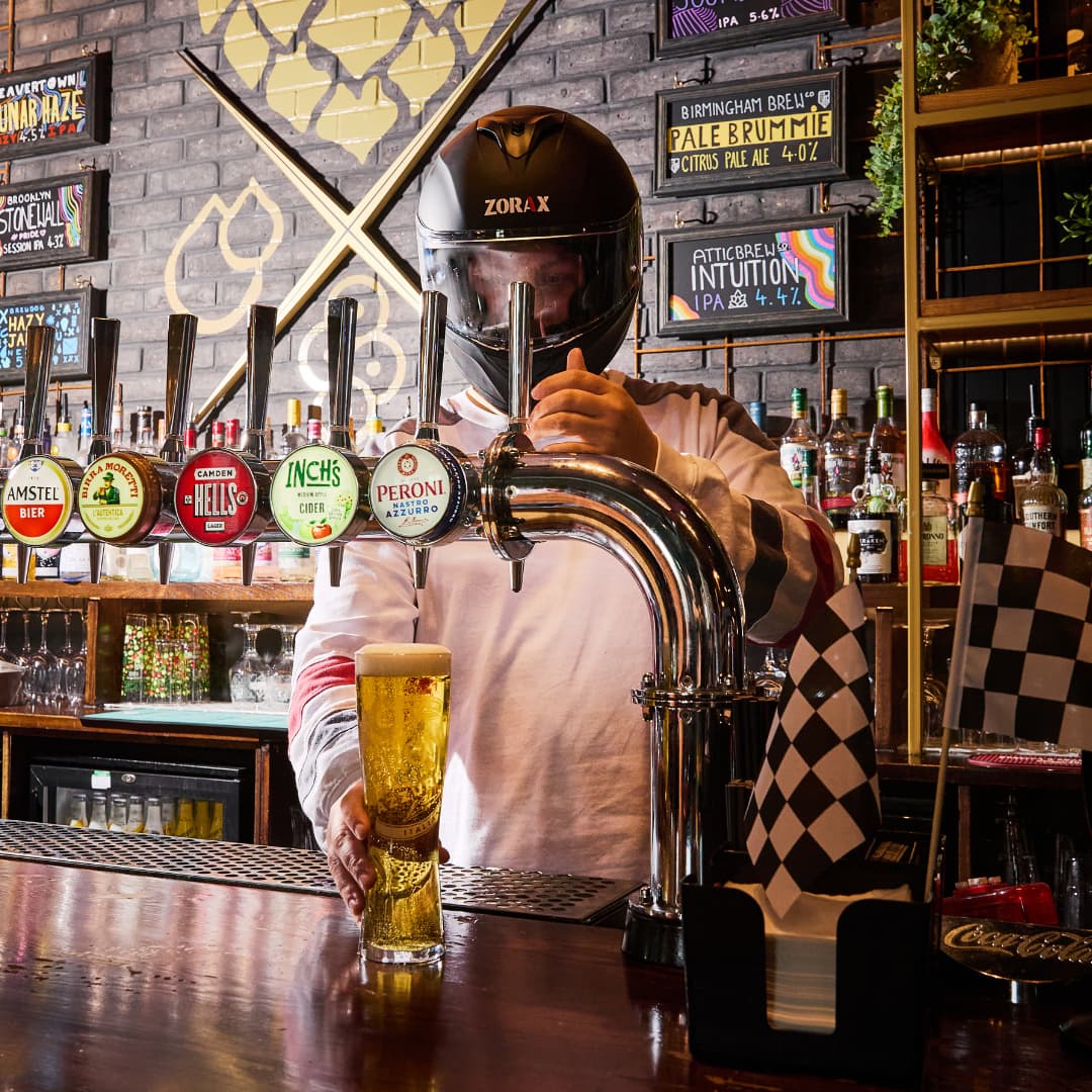 Pouring a pint in an F1 helmet