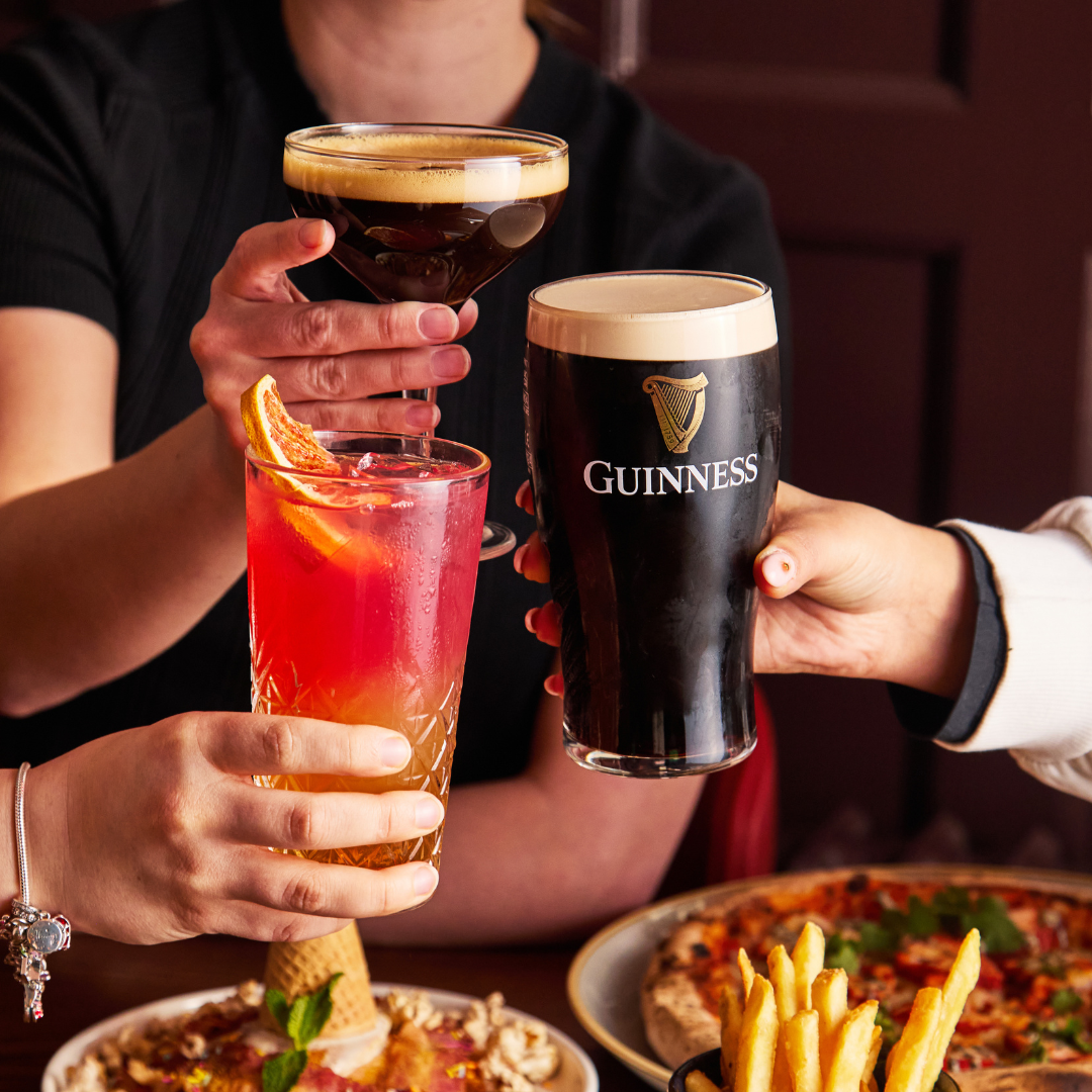 3 PEOPLE CHEERSING DRINKS AT BRUNCH 3 PEOPLE CHEERSING DRINKS AT BRUNCH