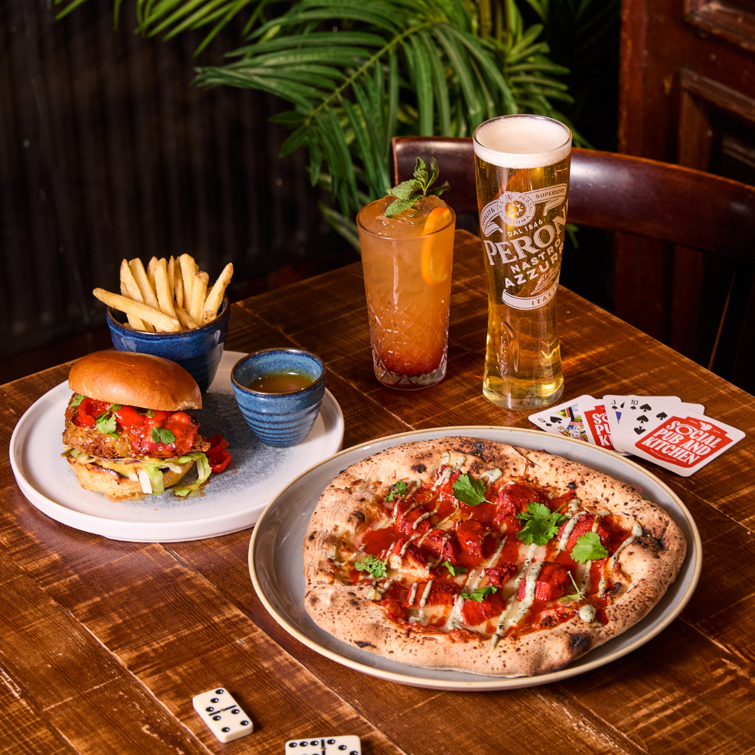 Pizza, burger and 2 drinks on table
