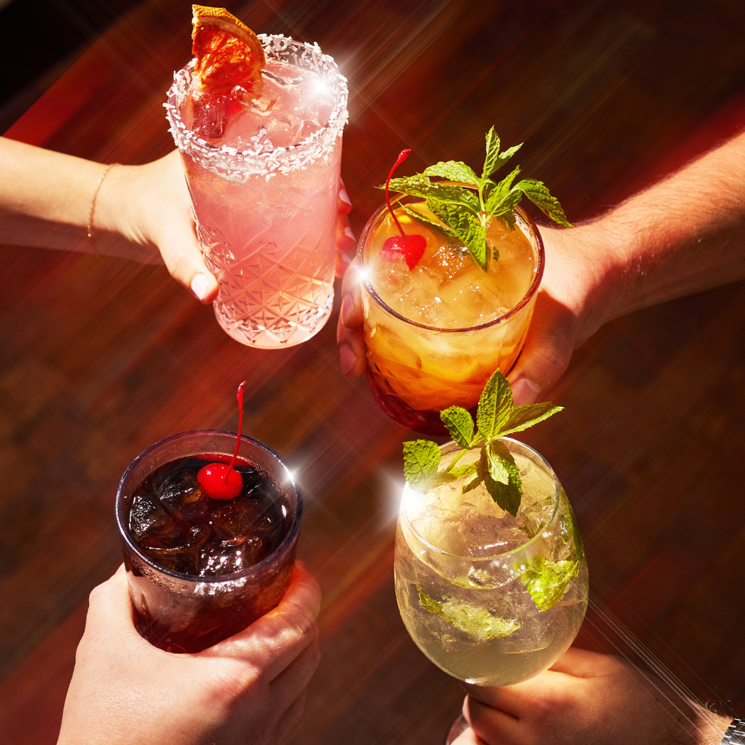 4 people cheersing cocktails